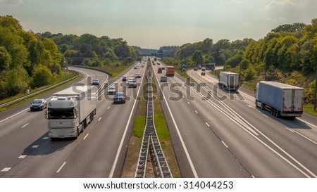 Right hand side Evening Traffic on the A12 Motorway through the Veluwe forest. One of the Busiest highways in the Netherlands Royalty-Free Stock Photo #314044253