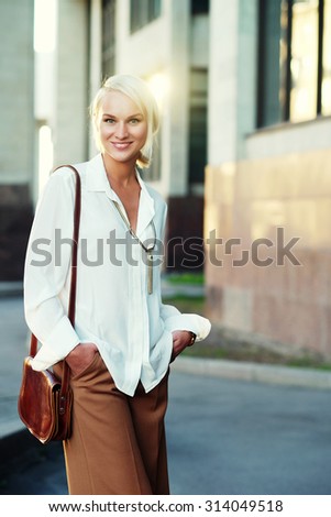 young blond woman walking on the street