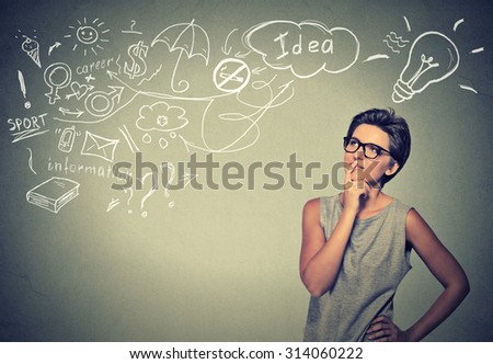 Portrait happy young woman thinking dreaming has many ideas looking up isolated grey wall background. Positive human face expression emotion feeling life perception. Decision making process concept.