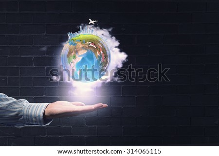 Human hand holding digital icon of planet earth. Elements of this image are furnished by NASA