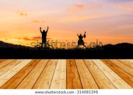 Wooden floor with children playing in sunset, silhouette, freedom and happiness 