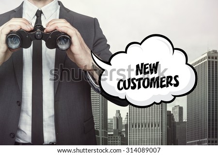 New customers text on speech bubble with businessman holding binoculars on city background