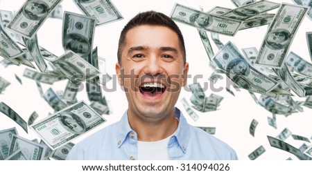 business, finance, success, emotions and people concept - laughing man with heap of falling dollar money