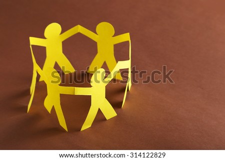 Paper people on the brown paper background