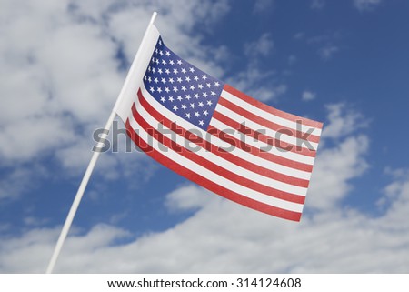 United States flag in front of a blue sky