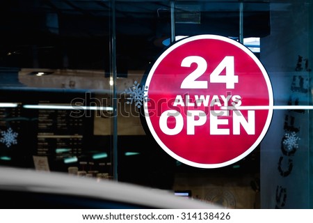 24 Hours Always Open Sign in front of the regular coffee shop in the city