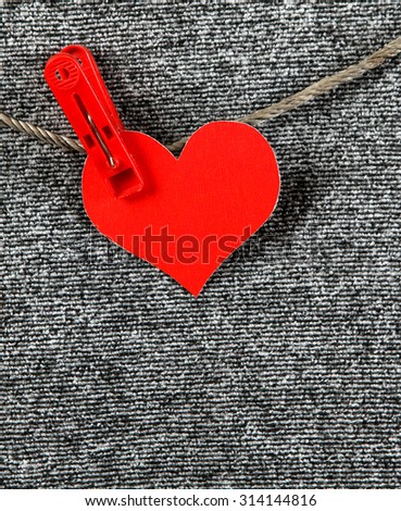 Red Heart Shape on the Rope on the Grey Textile Background