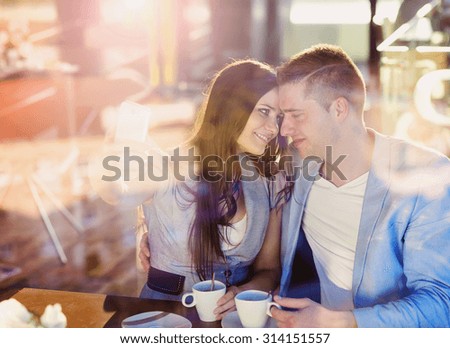 Double exposure of a beautiful young couple sitting in a cafe