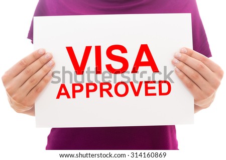 Girl holding white paper sheet with text Visa approved