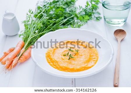 Carrot Soup on white wooden background