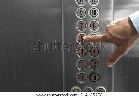 Forefinger pressing the fifth floor button in the elevator Royalty-Free Stock Photo #314165276