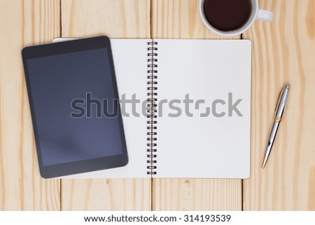 Blank notebook and tablet on wood table