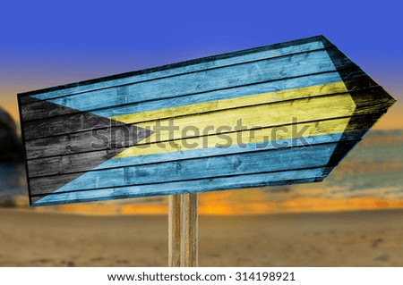 Bahamas Flag wooden sign on beach background