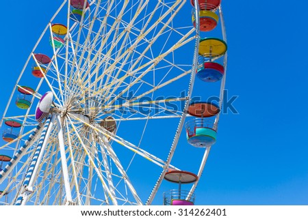 Giant ferris wheel in Amusement park with blue sky background