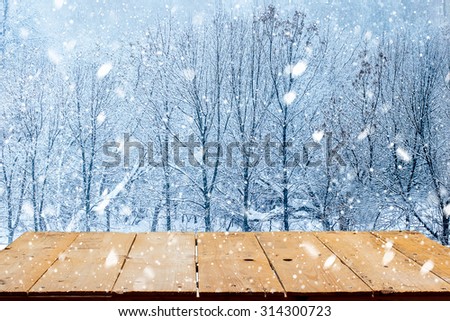 Yellow wooden desk top and winter landscape.  Christmas Card
