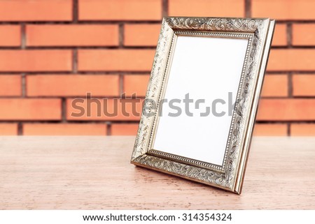 Old empty frame on brick wall background