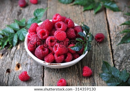 organic raspberries on a wooden background
