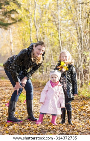 mother with her daughters in autumnal nature