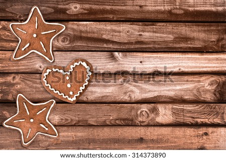 Ginger bread cookies and Christmas ornaments on wooden planks background