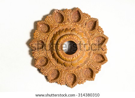 A decorative indian terra-cotta lamp. A craft. Royalty-Free Stock Photo #314380310