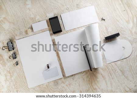 Photo of blank corporate identity template on light wooden background. For design presentations and portfolios.