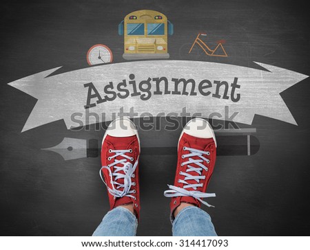 The word assignment and casual shoes against black background