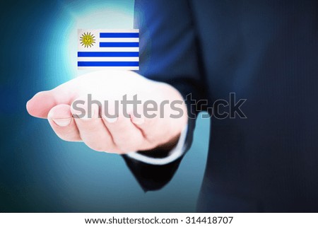 Mid section of a businessman with hands out against blue background