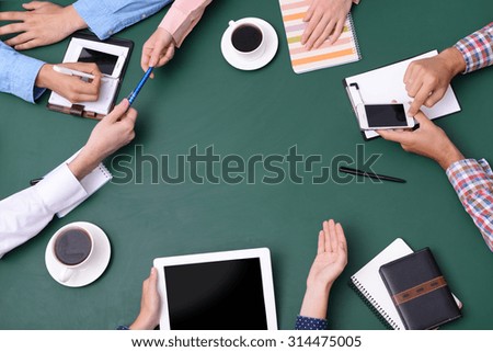 Top view of people hands at working process