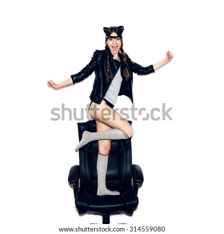 Woman with leather cat ears and braids having fun. On white background, not isolated