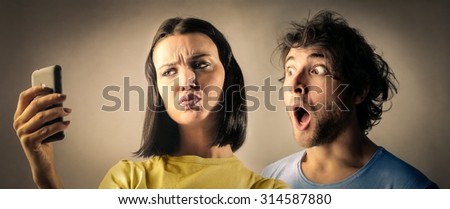 Shocked couple reading something on a phone