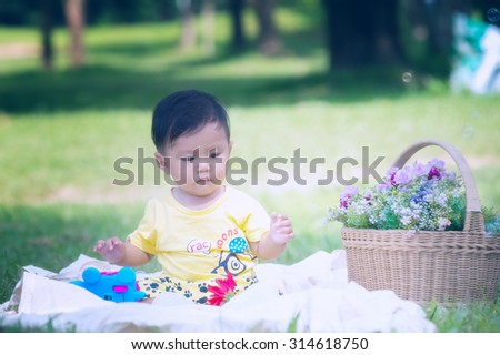 Asia Baby boy on green grass in the park , Chiangrai Thailand