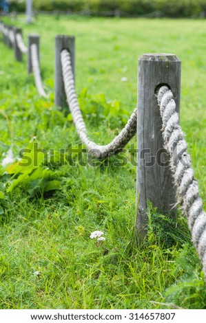 Decorative fence made from wooden posts and rope