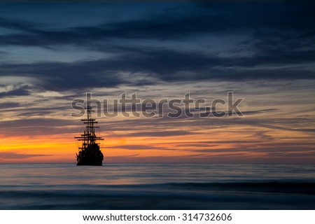 Pirate ship in sunset scenery.
