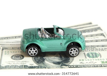 Green toy car on the dollars