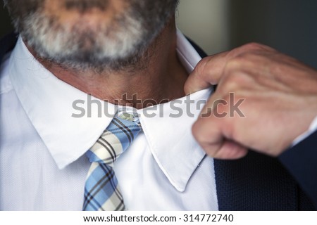 closeup of businessman loosens his shirt Royalty-Free Stock Photo #314772740