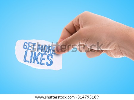 Piece of paper with the word Get More Likes with blue background