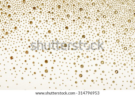 Gold rhinestones on fabric. White fabric decorated with gold jewels as background. Royalty-Free Stock Photo #314796953