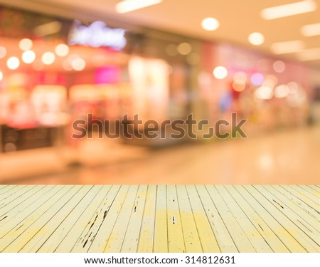 Blurred image of people walking at shopping mall , blur background with bokeh.