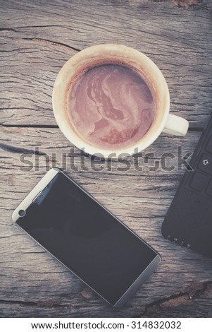 Hot chocolate with smart phone on office table