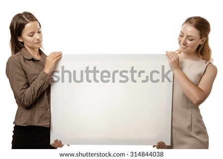 two business woman holding up a board