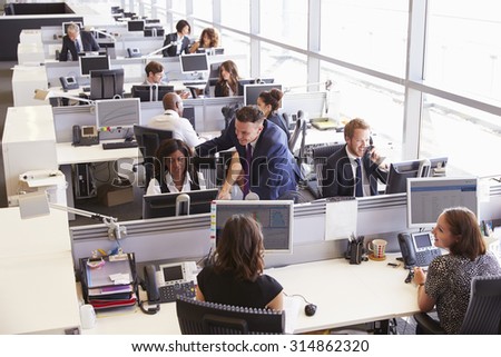 Manager in discussion with coworker in an open plan office Royalty-Free Stock Photo #314862320
