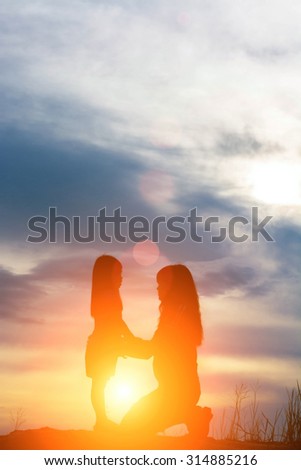 mother sitting holding hand daughter time of love