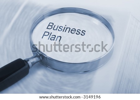 The words "Business Plan" under a magnifying glass. Book underneath has radial blur to suggest a whirlpool of ideas, with your Business Plan in sharp focus. See others from series in  portfolio.