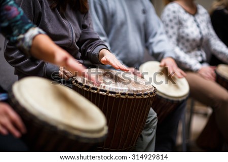 Group of people playing on drums - therapy by music Royalty-Free Stock Photo #314929814