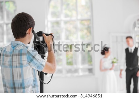 Wedding photographer taking photographs of wedding 