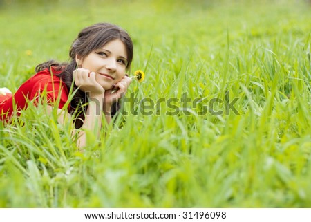 Picture of beautiful girl lying on the grass in the park