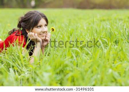 Picture of beautiful girl lying on the grass in the park