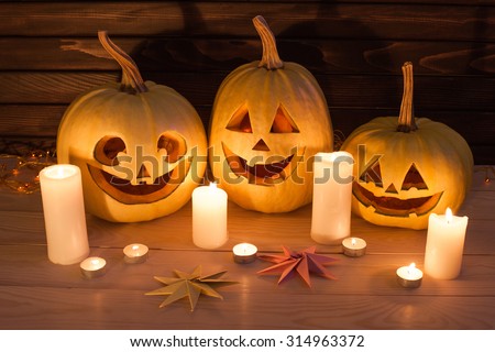 Scary Halloween pumpkins on wooden background