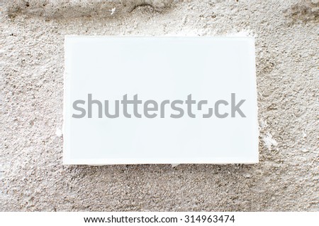 White and blank picture frame on a cement wall