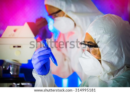 Scientists working in laboratory close up